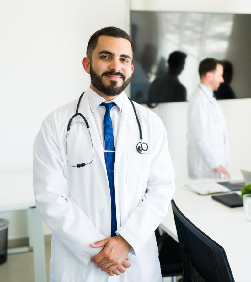 A happy Hispanic doctor in a hospital